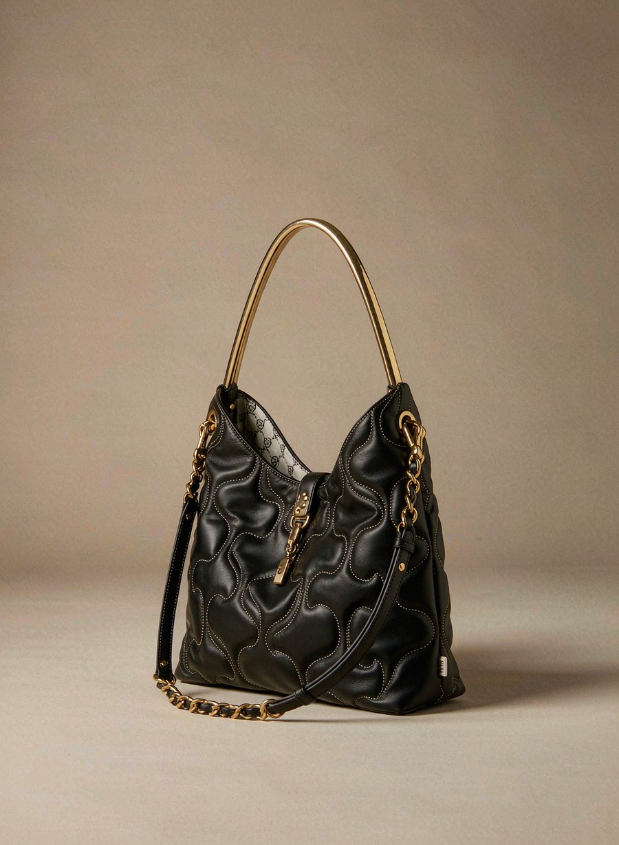 The Noir Chain Shoulder bag in black quilted leather with gold chain